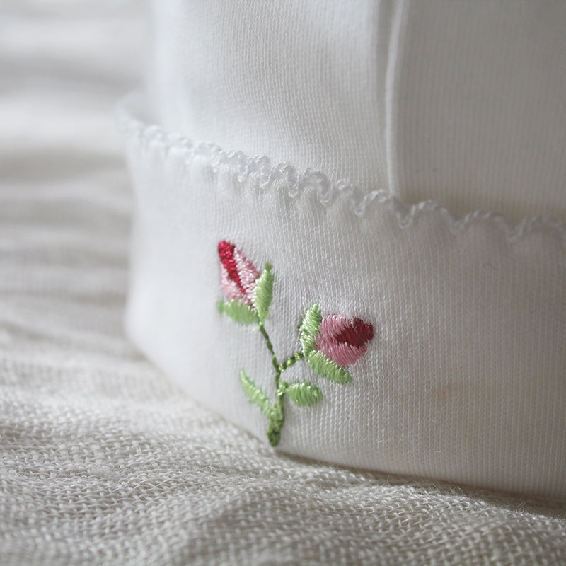 white pima cotton beanie with rosebuds