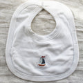 white cotton bib with sailboat