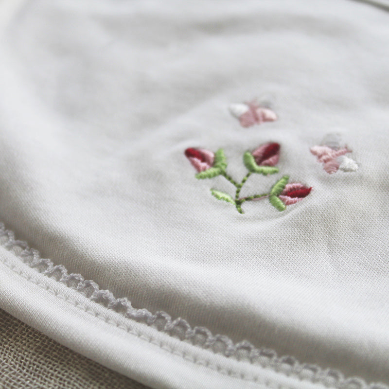 white cotton bib with rosebud