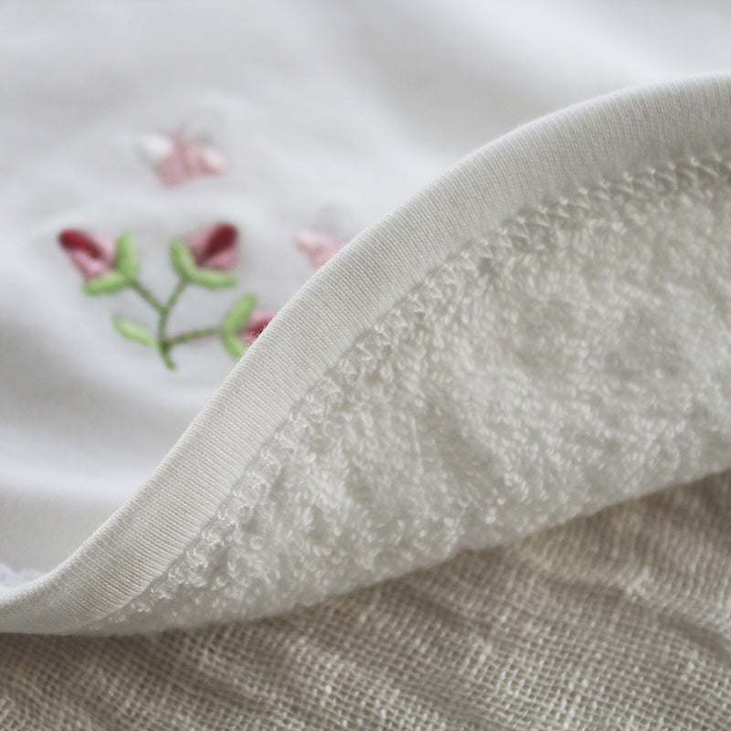 white cotton bib with rosebud