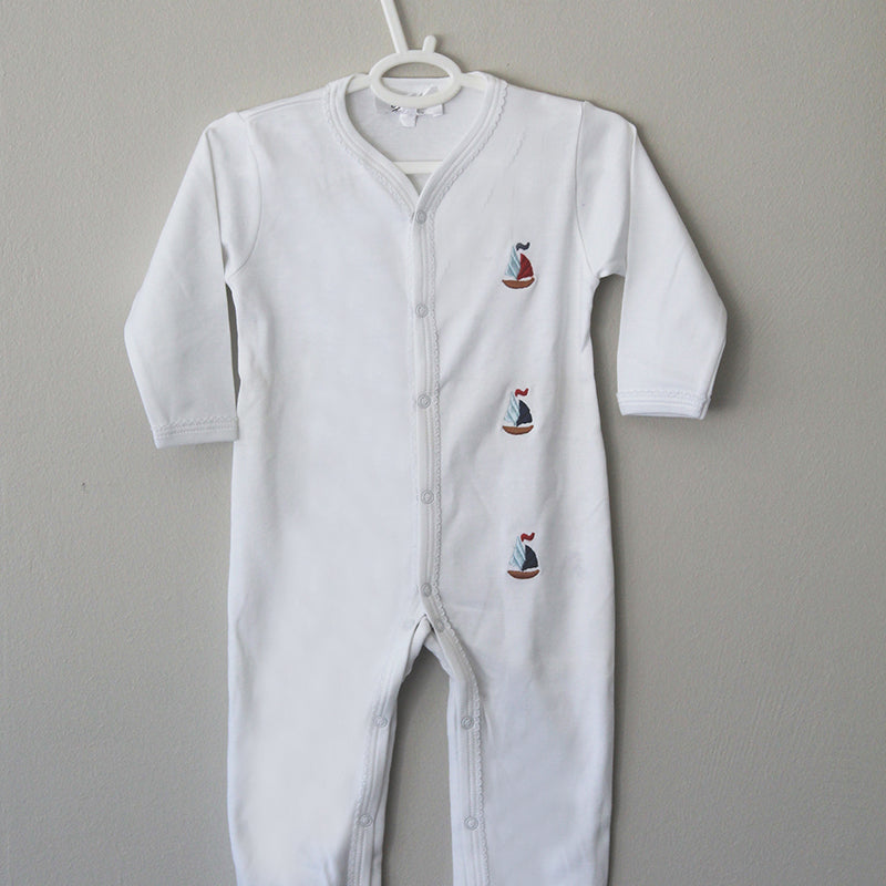 white cotton onesie with sailboats