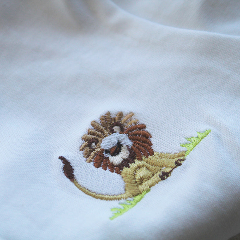 white cotton onesie with lion