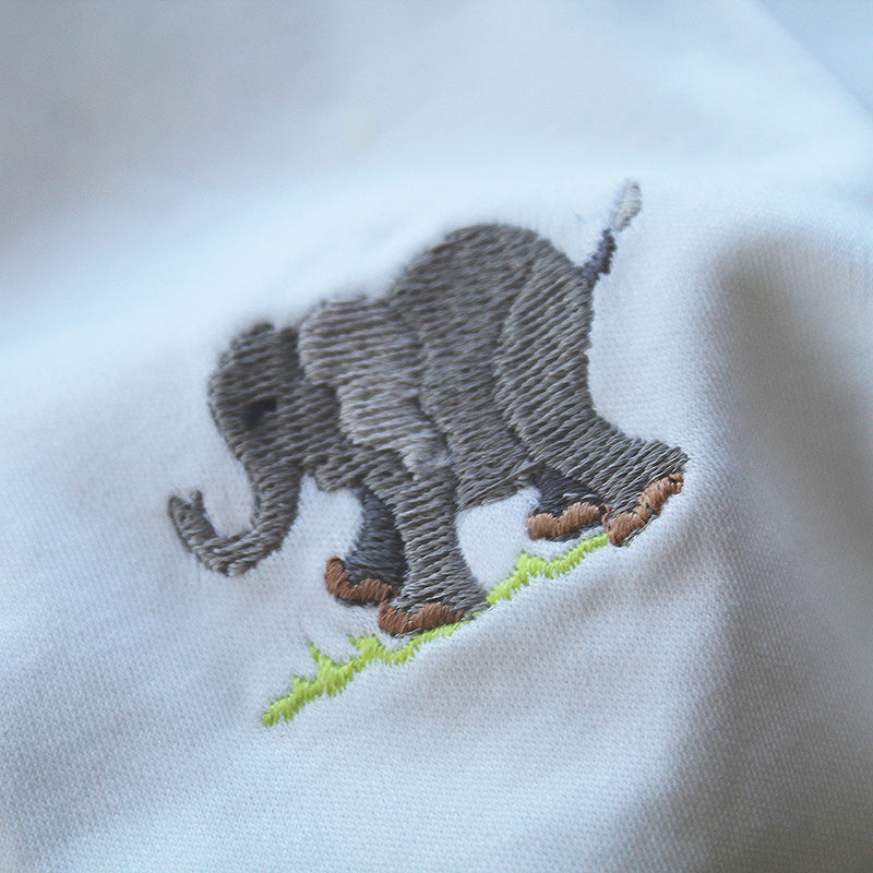 white cotton onesie with elephant