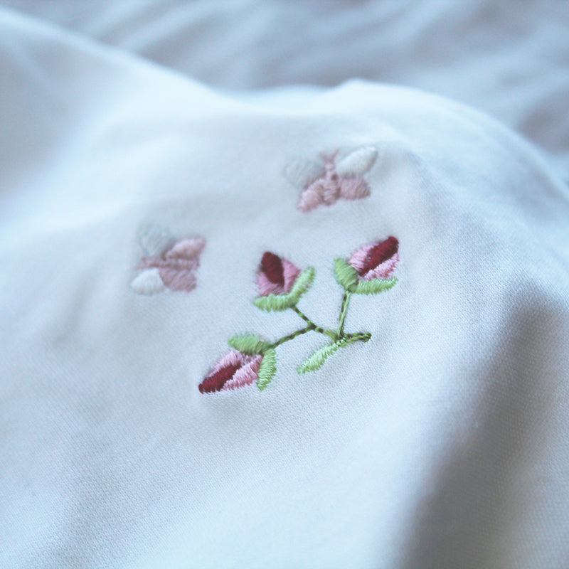 white cotton onesie with rosebud