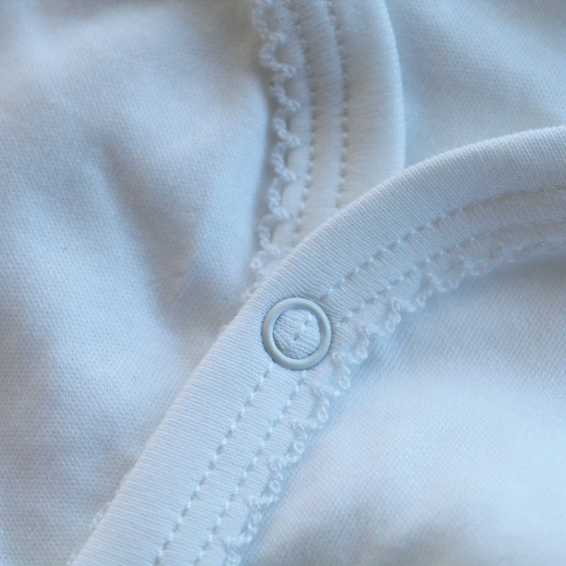 white cotton onesie with rosebud